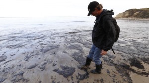 Longtime Santa Barbara resident Morgan Miller on May 19 walks on oil-coated sand at Refugio State Beach looking for wildlife to rescue. Emergency officials and Exxon Mobil were responding to a ruptured pipeline that was leaking crude oil into the ocean, authorities said